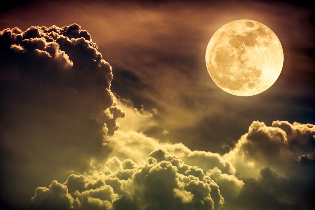 Super moon. Attractive photo of background night sky with cloudy and bright full moon. Nightly sky with beautiful full moon. Sepia tone. The moon were NOT furnished by NASA.