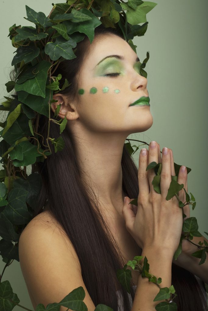 woman meditating - dressed in green soul 0ut breath