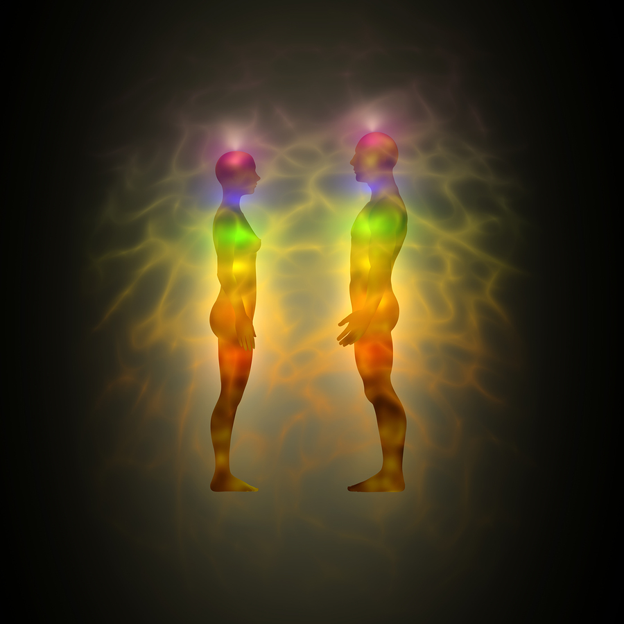Illustration of human energy body silhouette with aura and chakras. Body of woman and man. Theme of healing energy connection between the body and soul.