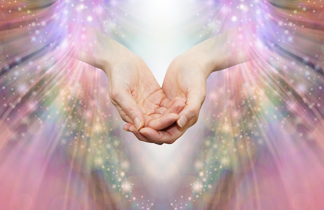 Hands offering high vibrational healing