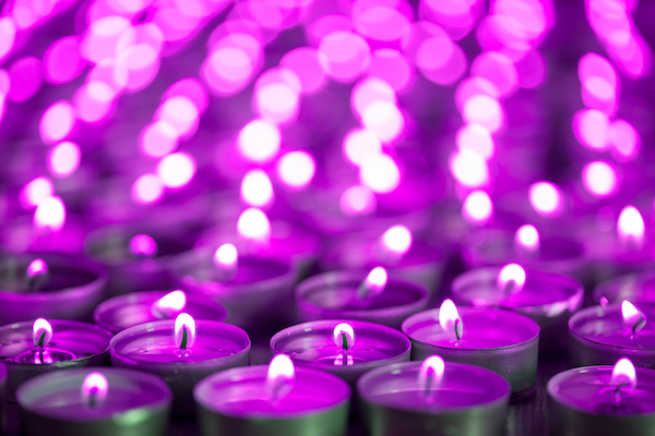 Purple candles lit at night