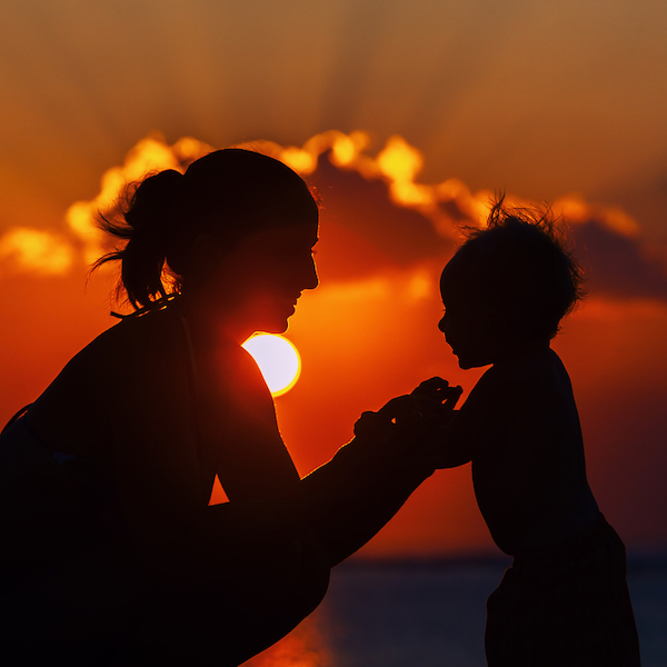 Happy Mother And Joyful child Sunset Silhouette