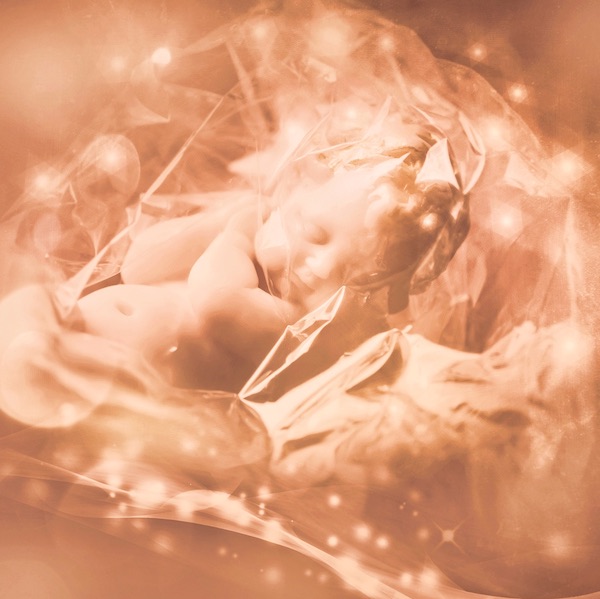 Baby sleeping surrounded by magical light