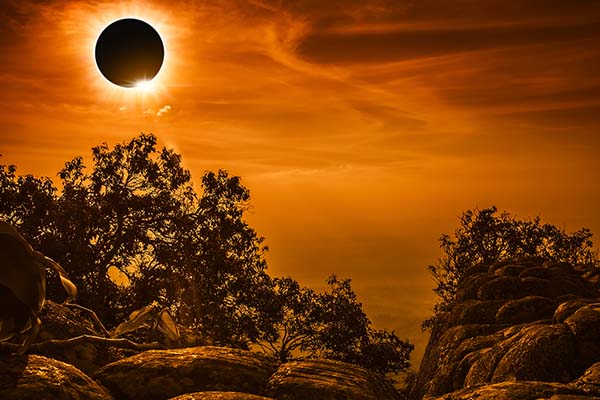 Solar eclipse glowing on orange sky 